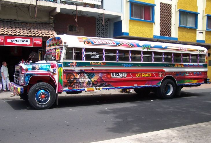 Coloured city bus carrying passengers in Ecuador