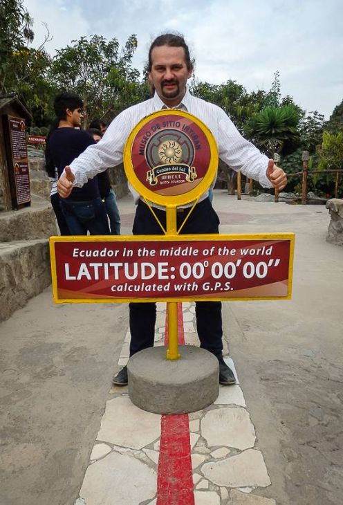 The man posing for the photo on the equator in Ecuador 