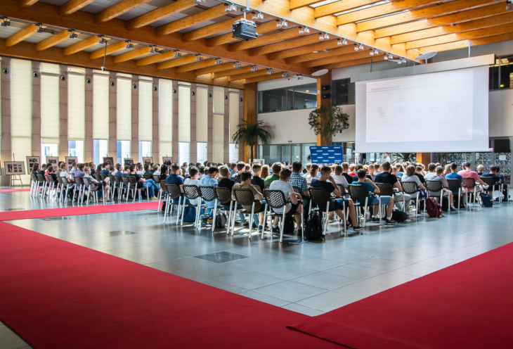  Students sit in the auditorium and listen to a lecture opening the summer IT internship