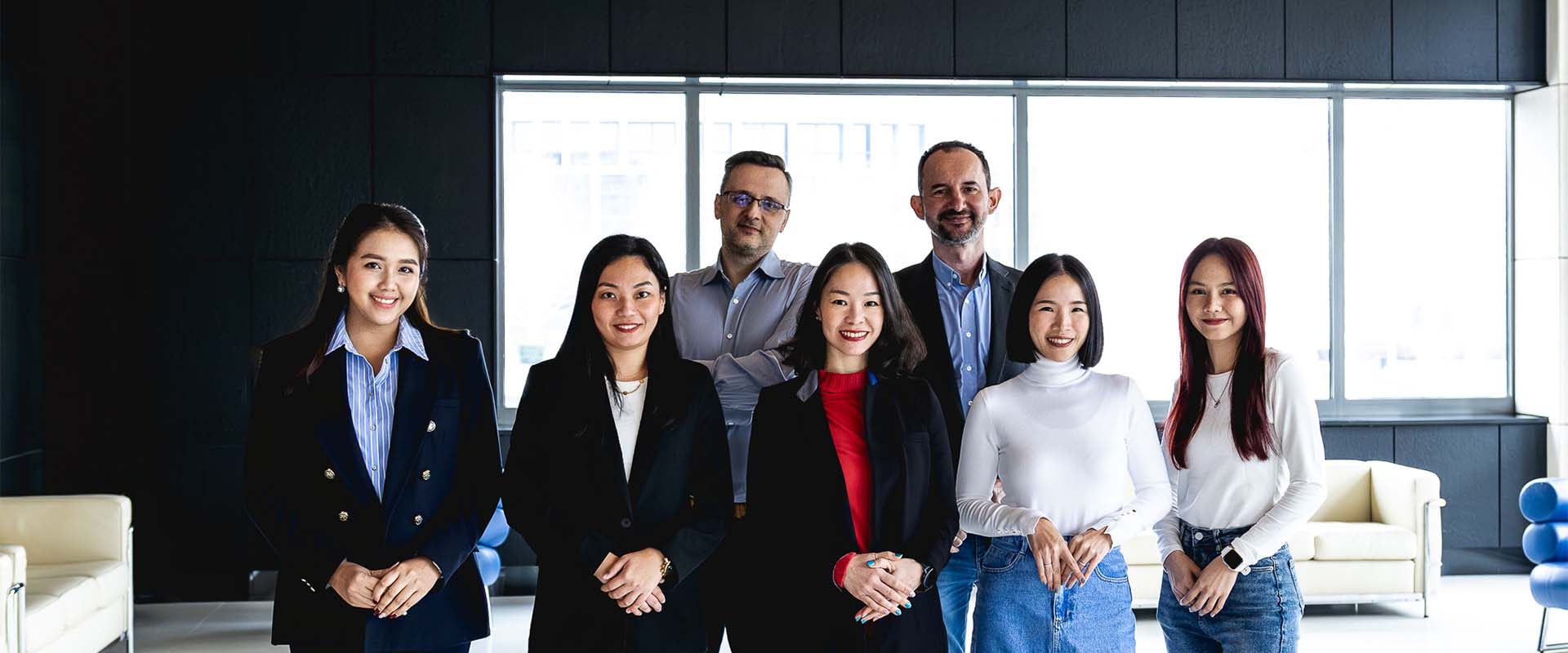 Thai employees posing and looking at the camera.