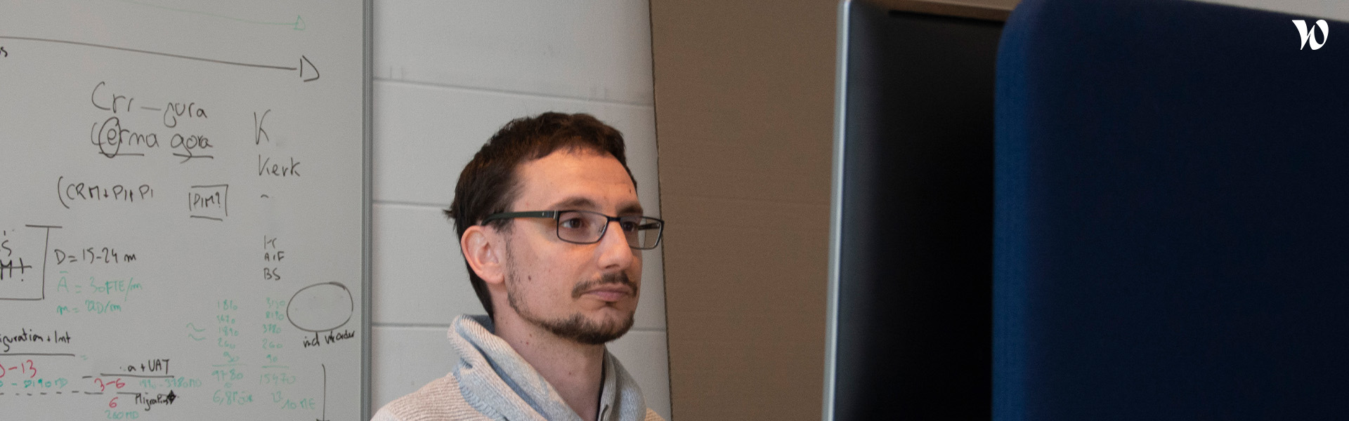 Man in glasses looking at something.