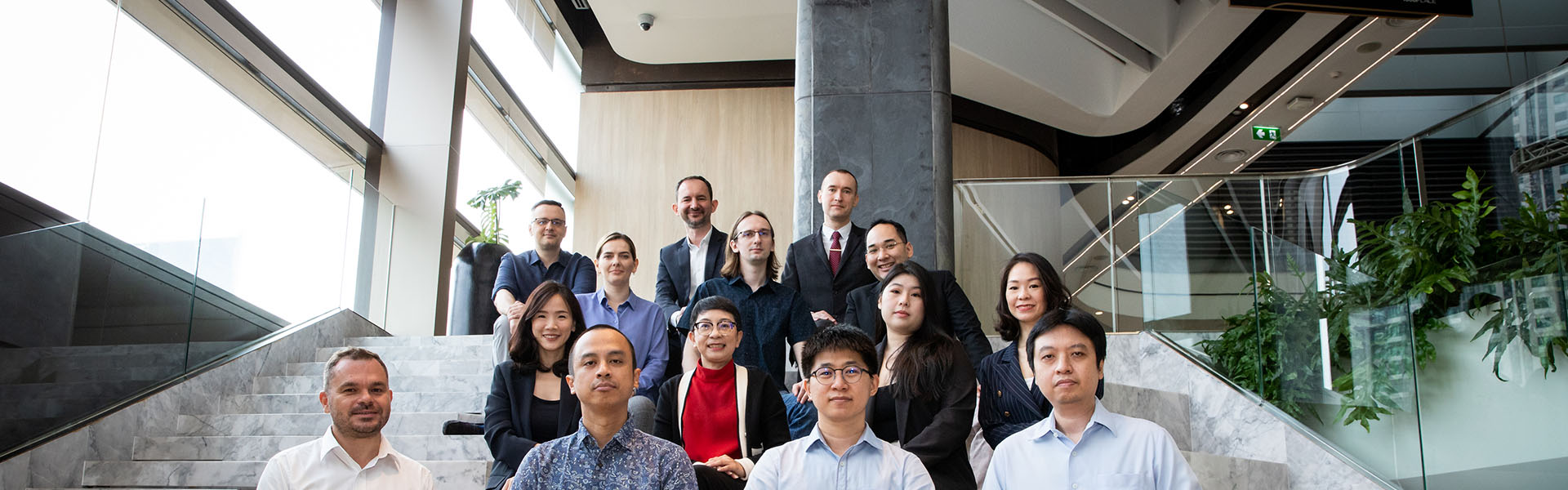 People sitting on the stairs, smiling and posing.