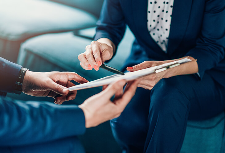 System analyst during operation. A woman shows important information on a tablet to a man.