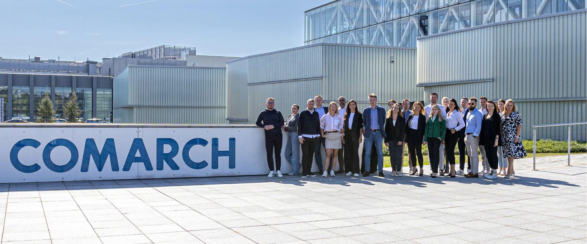 A group of colleagues posing to the picture in front of our office building