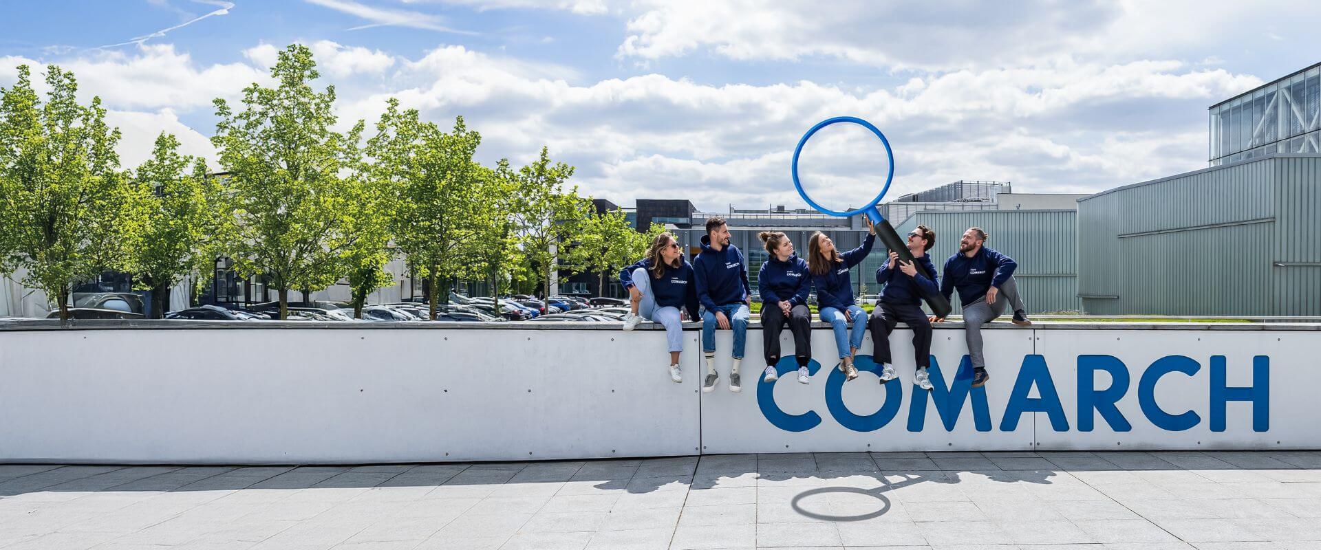 A group of colleagues posing to the picture in front of our office building