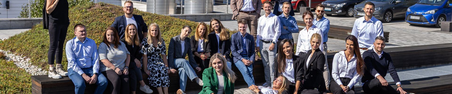 A group of comarch employees posing to the picture and enjoying the sunny weather in Krakow